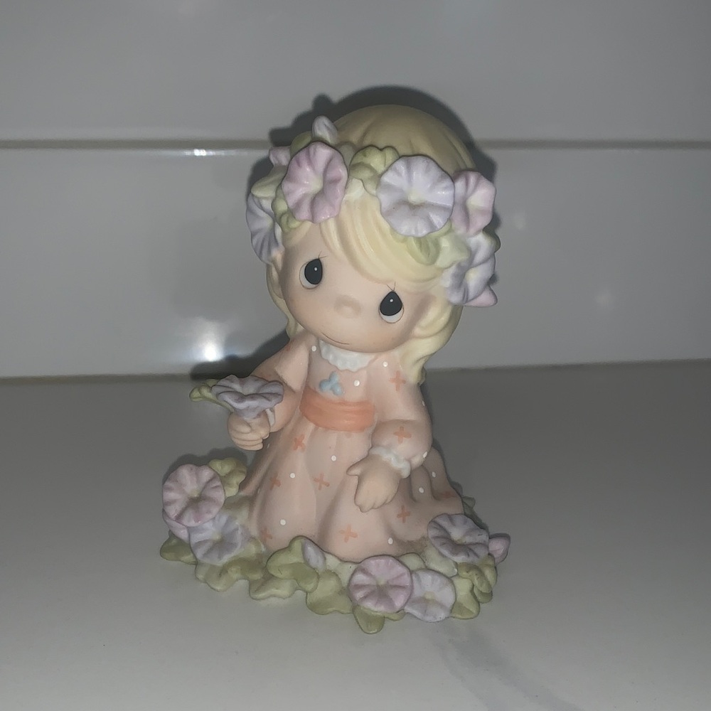 Precious Moments Figurine with Soft Green and Purple Accents